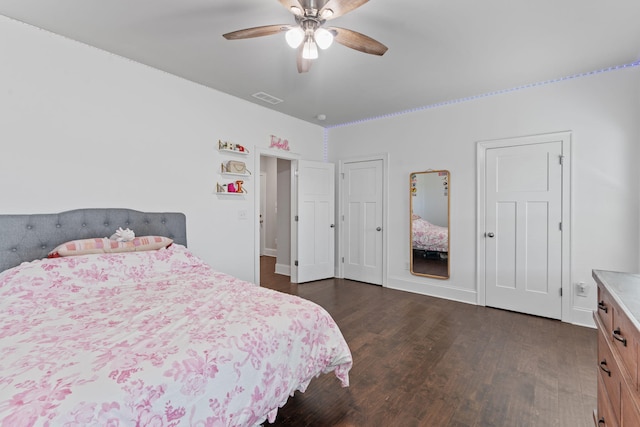 bedroom with ceiling fan and dark hardwood / wood-style flooring