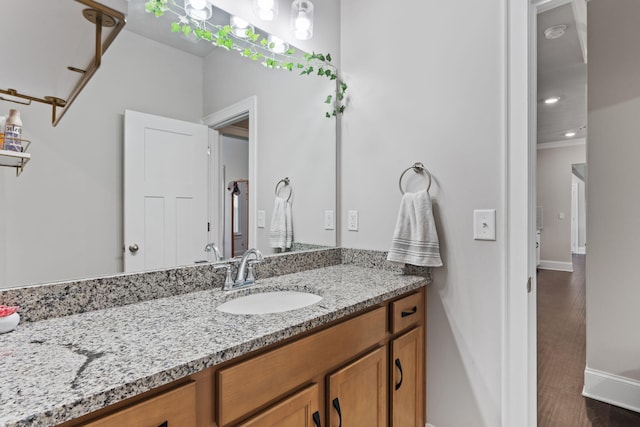 bathroom with hardwood / wood-style floors and vanity