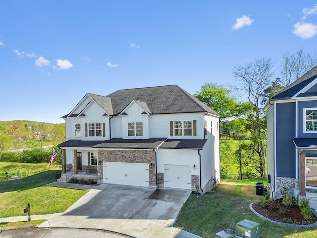 view of front of house with a front yard and a garage