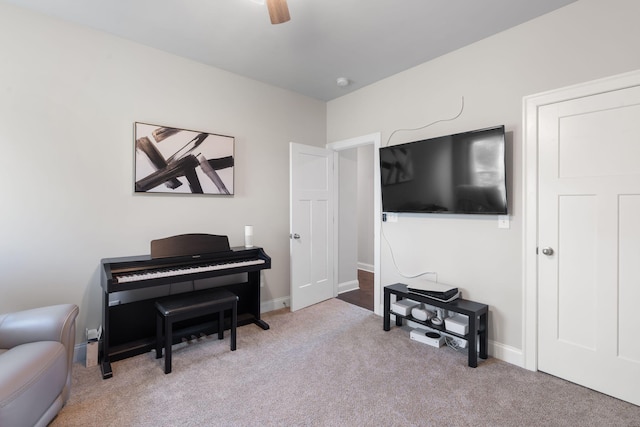 interior space with ceiling fan and light carpet