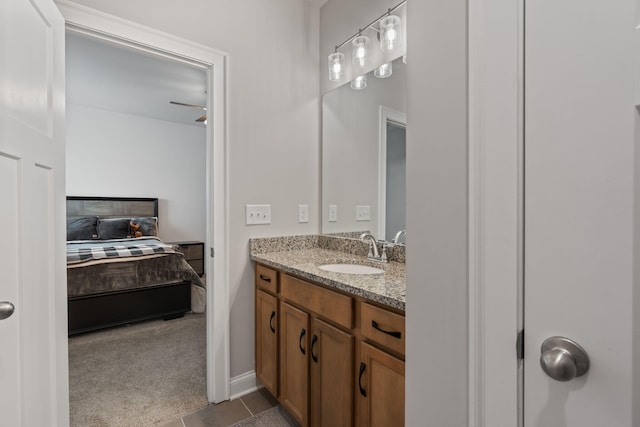 bathroom with tile patterned flooring, vanity, and ceiling fan