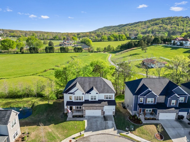 birds eye view of property with a rural view