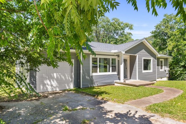 ranch-style home with a front yard and a garage