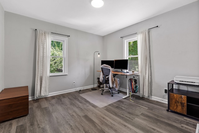 office area with a wealth of natural light and dark wood-type flooring