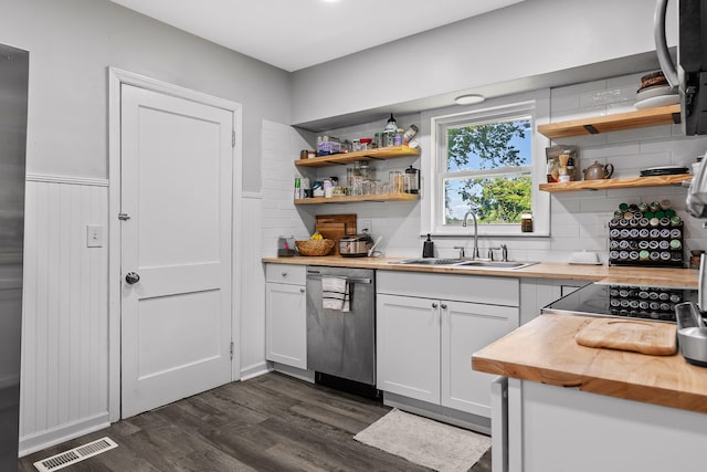 kitchen with sink, dishwasher, wood counters, dark hardwood / wood-style flooring, and white cabinets