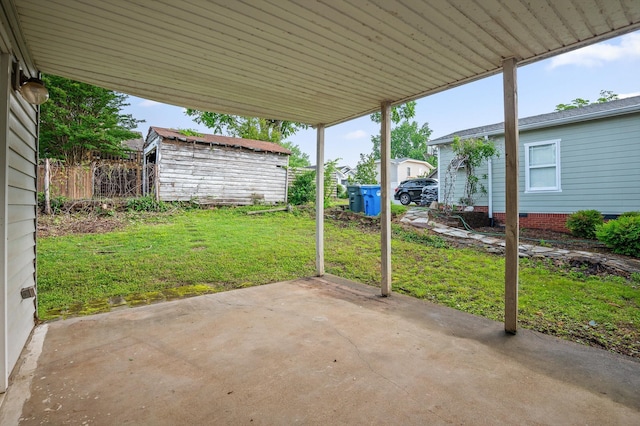 view of patio / terrace with a storage shed, a carport, and an outdoor structure