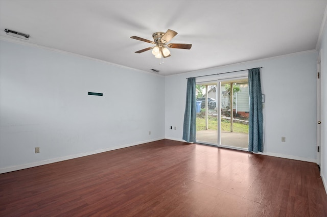 spare room featuring dark wood-style flooring, ornamental molding, baseboards, and a ceiling fan