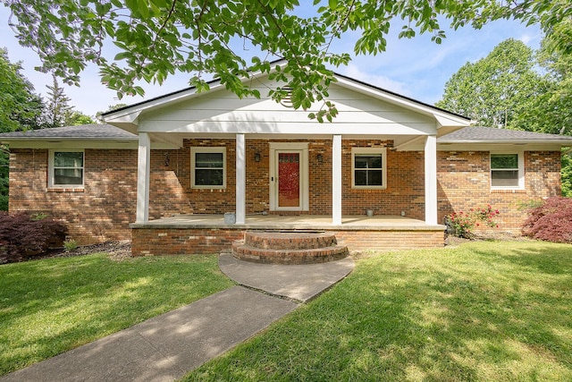 ranch-style house with a front lawn, a porch, and brick siding
