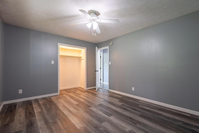 unfurnished bedroom featuring ceiling fan, baseboards, a closet, and wood finished floors
