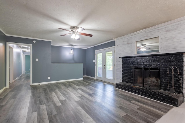 unfurnished living room with a ceiling fan, french doors, a textured ceiling, crown molding, and wood finished floors