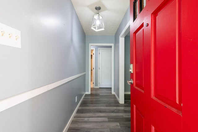 hall with baseboards and dark wood-style flooring