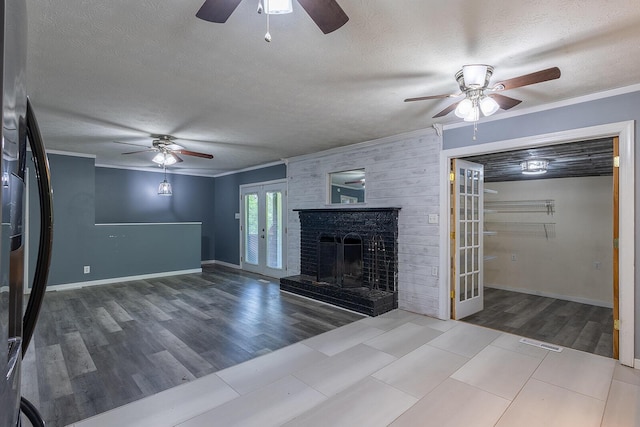 unfurnished living room featuring a textured ceiling, french doors, a ceiling fan, and ornamental molding