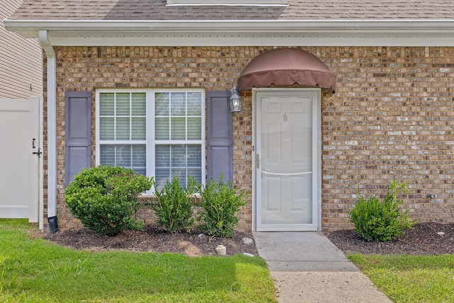 7510 Noah Reid Rd, Chattanooga, TN 37416 - view of exterior entry featuring a shingled roof and brick siding