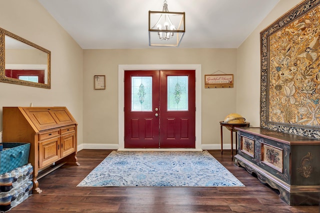 entrance foyer featuring a chandelier and dark wood-type flooring