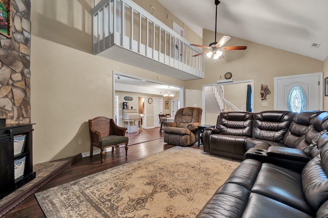 living room with hardwood / wood-style floors, ceiling fan with notable chandelier, and high vaulted ceiling