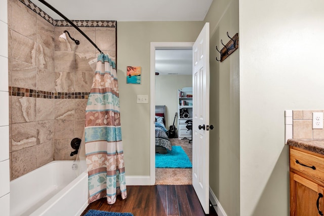 bathroom with shower / bathtub combination with curtain, vanity, and wood-type flooring