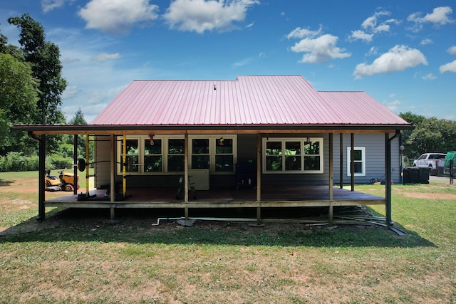 rear view of property with a lawn