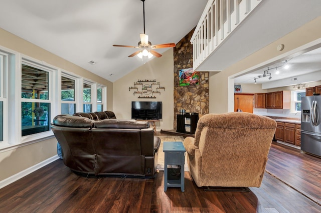 living room featuring dark hardwood / wood-style flooring, high vaulted ceiling, and ceiling fan