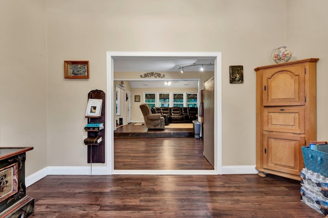 entrance foyer featuring dark hardwood / wood-style flooring and track lighting