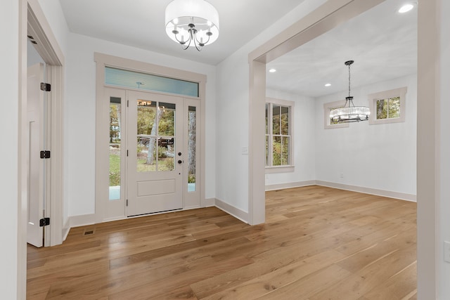 foyer featuring light hardwood / wood-style floors and a notable chandelier