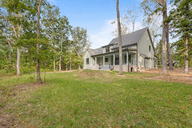 back of property featuring a porch and a yard