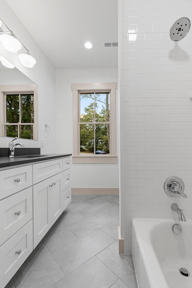 bathroom featuring vanity and tiled shower / bath combo