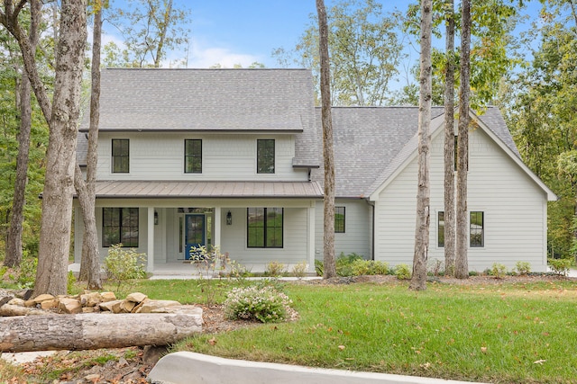 view of front of home with a porch and a front yard