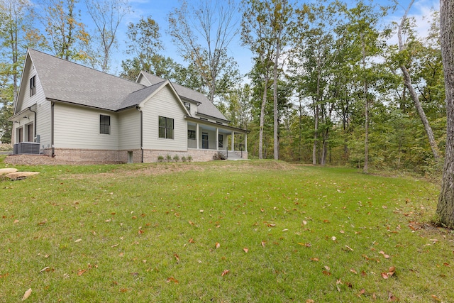 view of property exterior featuring a garage, a yard, and central air condition unit