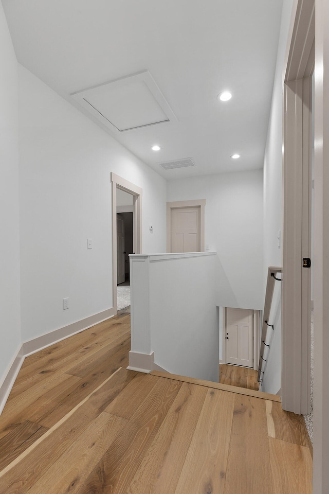 corridor with light hardwood / wood-style floors