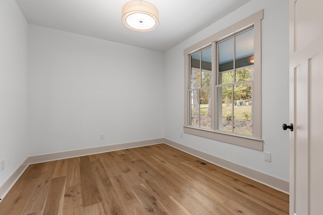 spare room with light hardwood / wood-style flooring