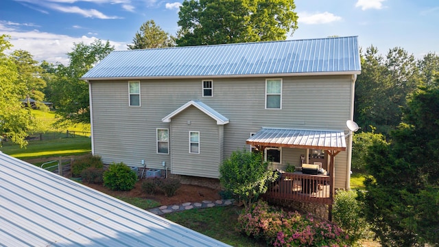 310 Moore Circle Rd, Charleston, TN 37310 - rear view of property with metal roof, fence, and a deck