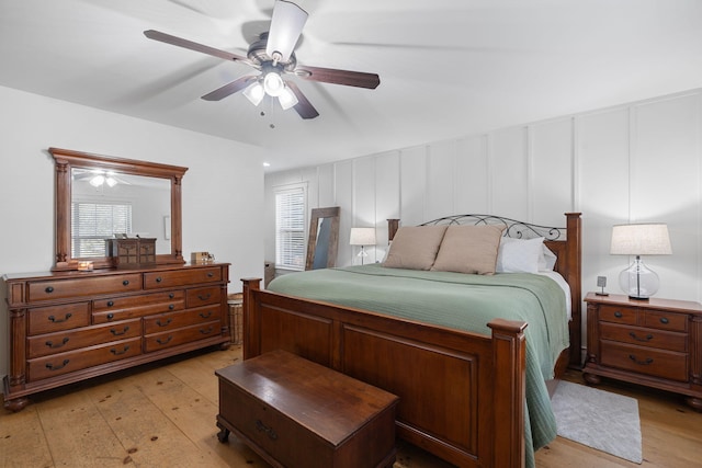 310 Moore Circle Rd, Charleston, TN 37310 - bedroom featuring light wood-style flooring, a decorative wall, and ceiling fan