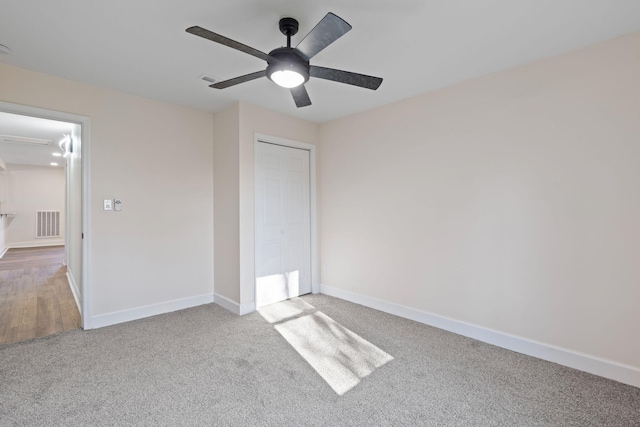 unfurnished bedroom with carpet, ceiling fan, and a closet