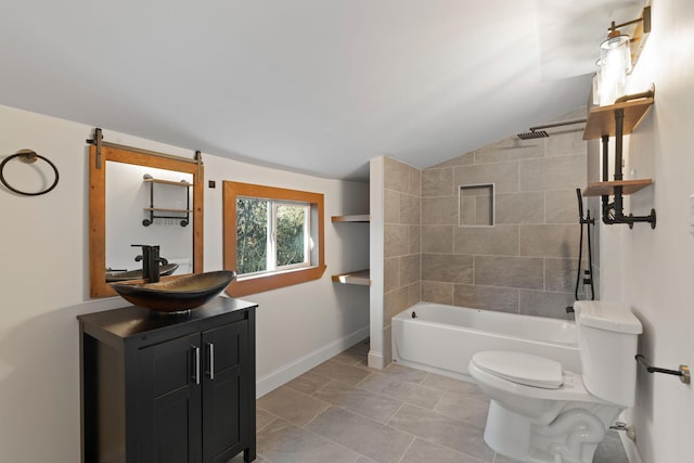 full bathroom with tiled shower / bath combo, vaulted ceiling, vanity, and toilet