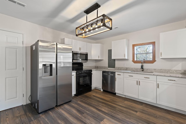 kitchen with sink, hanging light fixtures, stainless steel appliances, dark hardwood / wood-style floors, and white cabinets