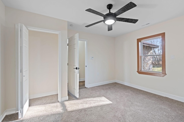 unfurnished bedroom featuring light carpet, a closet, and ceiling fan