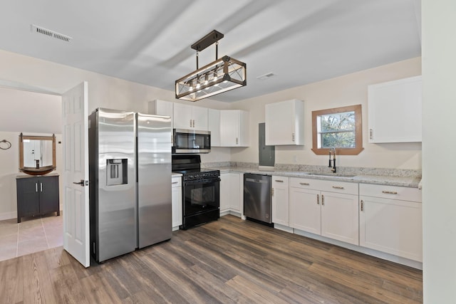 kitchen featuring stainless steel appliances, white cabinetry, and sink