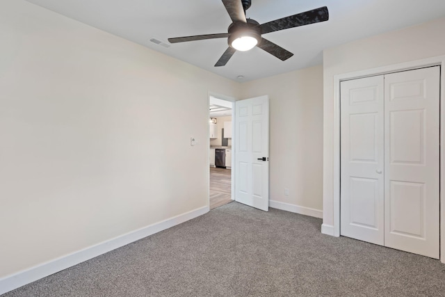 unfurnished bedroom featuring carpet floors, a closet, and ceiling fan