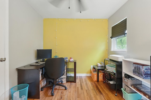 office area with light wood-style flooring and ceiling fan
