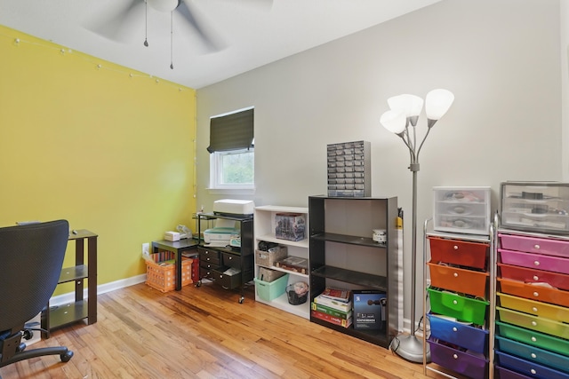 home office with wood finished floors, ceiling fan, and baseboards