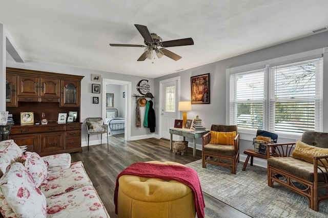 living room featuring dark hardwood / wood-style flooring and ceiling fan