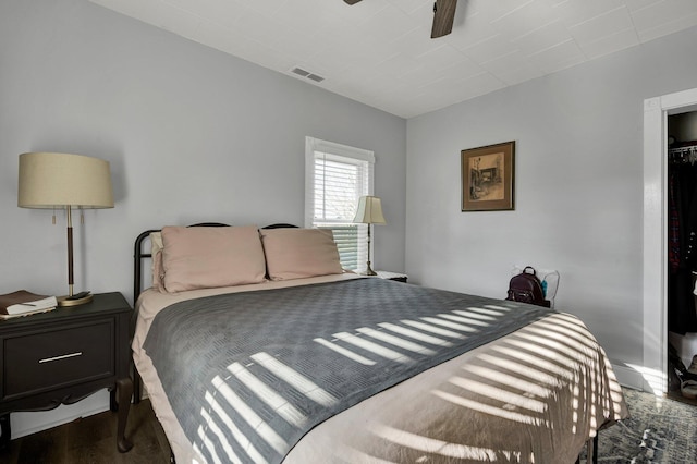 bedroom with a closet, ceiling fan, and dark hardwood / wood-style flooring