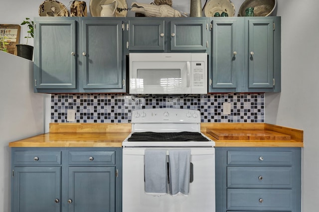 kitchen with white appliances, tasteful backsplash, and butcher block countertops