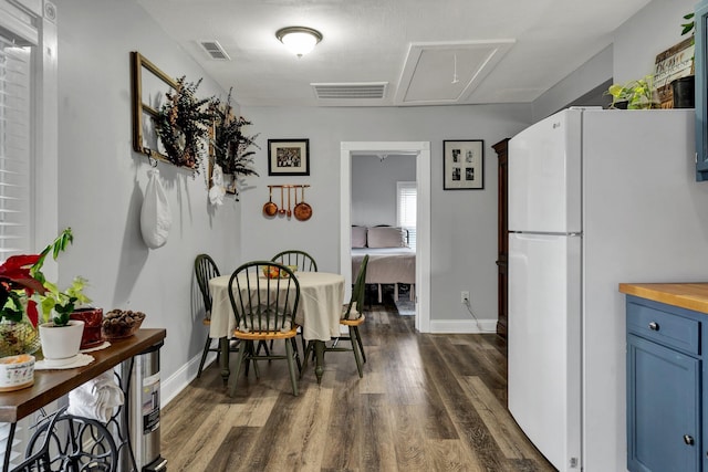 dining area with dark hardwood / wood-style flooring