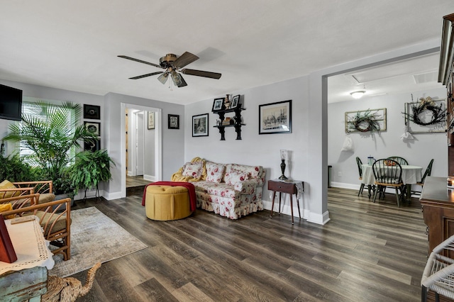 living room featuring ceiling fan and dark hardwood / wood-style flooring