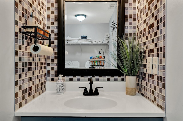 bathroom featuring vanity and tasteful backsplash