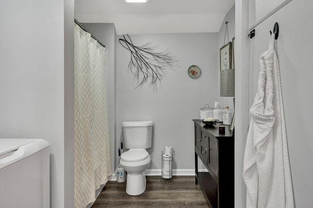 bathroom with hardwood / wood-style floors, vanity, and toilet