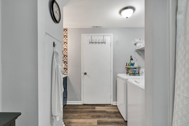 laundry area featuring washing machine and dryer and dark wood-type flooring