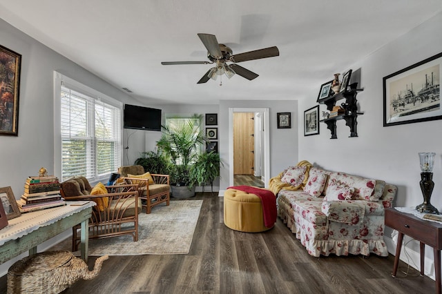 living room featuring ceiling fan and dark wood-type flooring