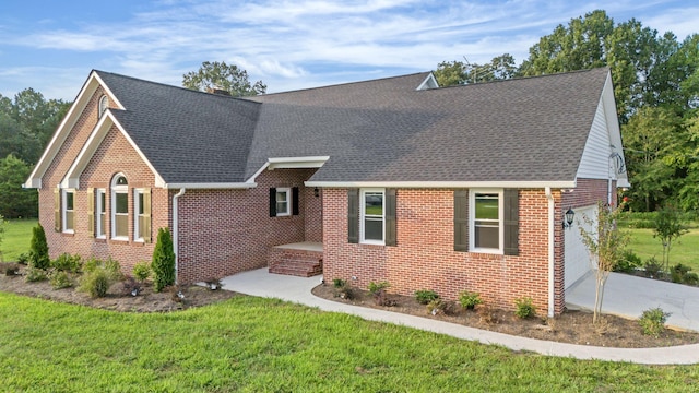 view of front of property with a front yard and a garage